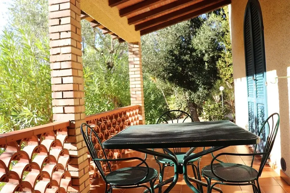 Covered veranda at La Paolina with table and chairs
